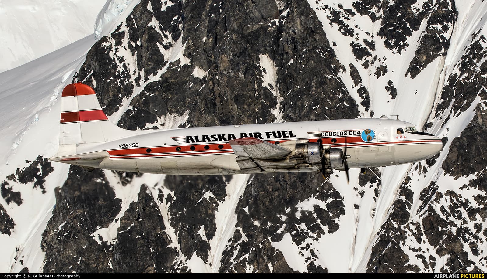 DC-4 flying over winter mountains